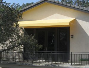 Yellow awning fabric on a residential porch awning