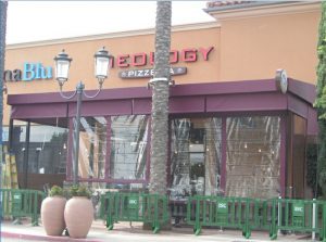 Maroon storefront awning for a pizzeria