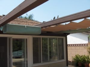 Green and gold retracted slide on wire awning