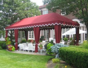 Large residential cabana with red awning fabric and drapes