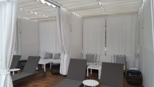White retractable awning and drapes
