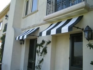 Striped white and green residential awnings