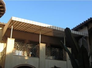 Custom patio shade awning with striped white and tan awning fabric