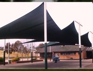 Black commercial sun shade panels for a parking lot