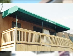 Commercial patio shade awning with green awning fabric for Toll Brothers Inc