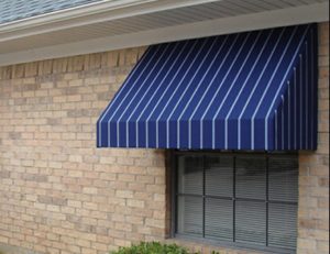 Striped white and blue awning fabric on a residential window awning