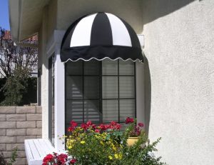 Black and white awning fabric on a residential dome window awning