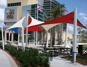 White, blue, red, and tan commercial sun shade panels for an outdoor area
