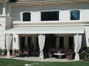 Residential patio shade awning with custom awning fabric and drapes