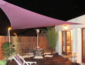 Burgundy residential sun shade panel on a patio