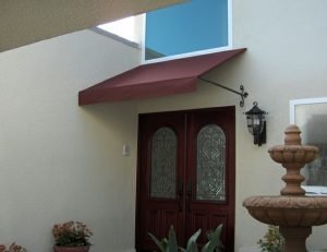 Maroon awning fabric on a residential entrance awning