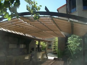 Residential trellis cover with tan slide on wire awning fabric