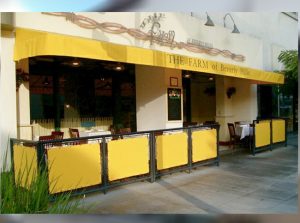 Custom yellow storefront awning for The Farm of Beverly Hills