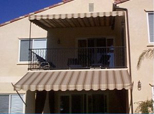 Residential patio shade awnings with striped awning fabric