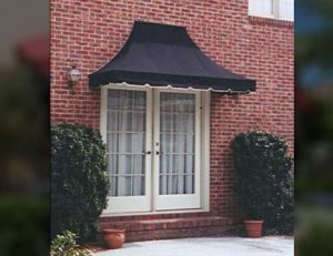 Backyard residential entrance awning with black awning fabric