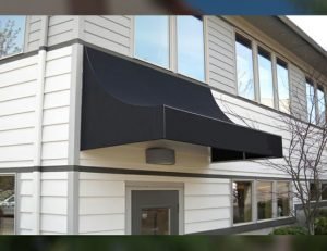 Black awning fabric on residential entrance awning