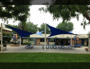 Blue commercial sun shade panels for a patio