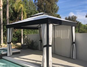 Small cabana with custom black and white awning fabric