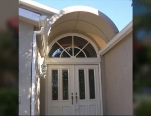 Residential entrance awning with tan awning fabric