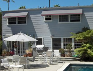 Grey awning fabric on residential window awnings