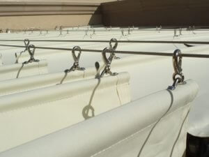Close up of a slide on wire awning with white awning fabric