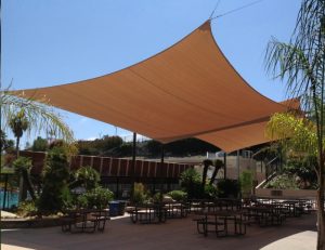 Brown commercial sun shade panels for an outdoor patio