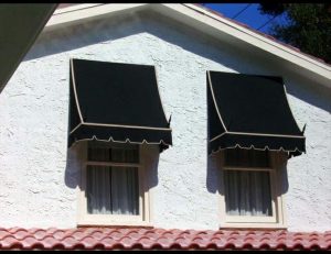 Black and gold residential window awnings with spearhead iron rods