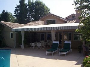 Patio shade awning with grey and white striped awning fabric