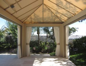 Large cabana with beige awning fabric and custom outdoor drapes