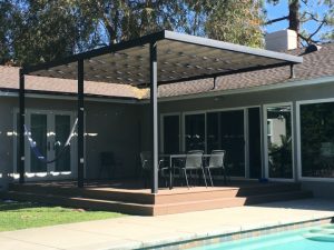 Dark residential slide on wire awning with white awning fabric