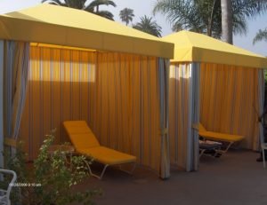 Commercial cabanas with yellow and white custom awning fabric