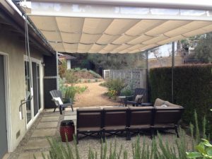 Residential slide on wire awning with tan awning fabric