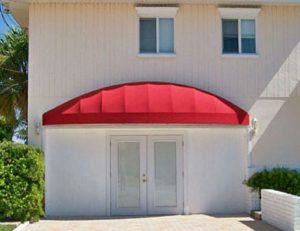 Residential awning with red awning fabric
