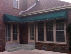Green awning fabric on a custom residential entrance awning