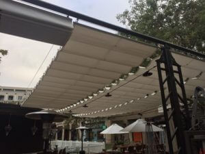Metal awning with white slide on wire awning fabric
