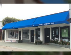 Blue commercial awnings for Corner Construction and Merchant Marine