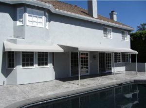 Light grey patio shade awnings for a pool area