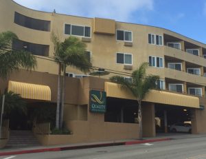 Striped white and yellow commercial awning for Quality Inn