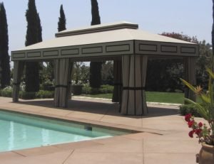 Custom cabana with olive awning fabric next to a pool