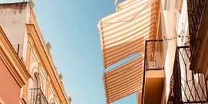 Stripped orange and white custom retractable awnings