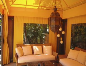 Custom cabana with yellow awning fabric and custom drapes