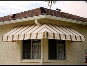 Custom residential window awning with striped awning fabric