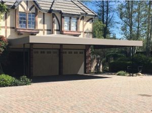 Dark tan awning fabric on a patio shade awning over a garage