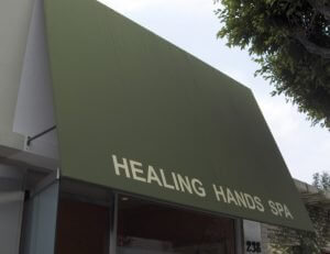 Green commercial awning for Healing Hands Spa