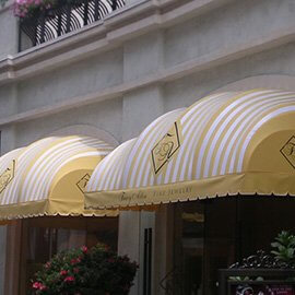 Custom storefront awning with white and gold fabric