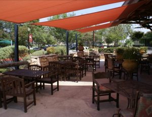Commercial tension sun shades with red awning fabric
