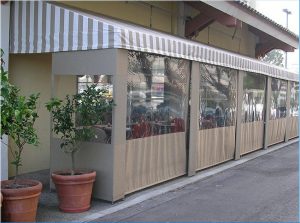 Beige storefront awning with white striped awning fabric