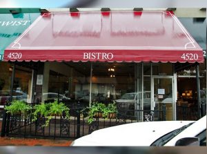 Red storefront awning and patio awning for a bistro