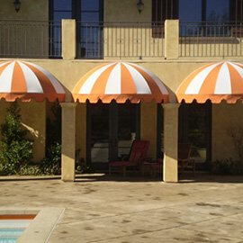 Striped pool awning with white and orange fabric