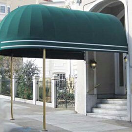Custom entrance awning with green fabric and gold accents